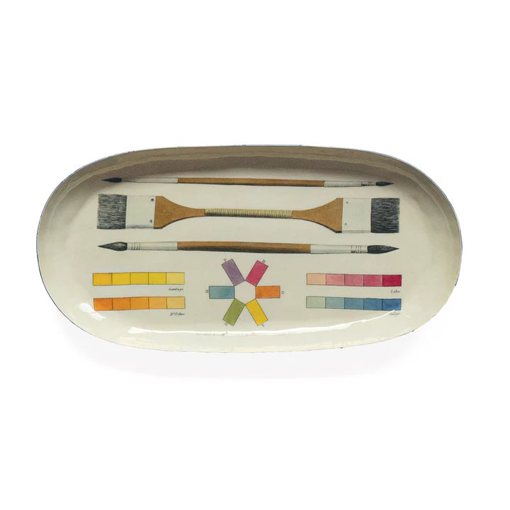 Top view of enamel tray with art tool illustrations against a white background.