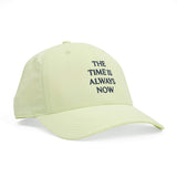 Side view of The Time is Always Now baseball hat in mint green.