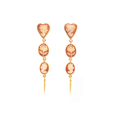 A pair of earrings each with three charms featuring a cameo and rose in white against pink.