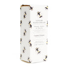 Box of luxury hand cream with bee design on a white background