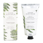 Luxury hand cream with packaging featuring fern design on a white background