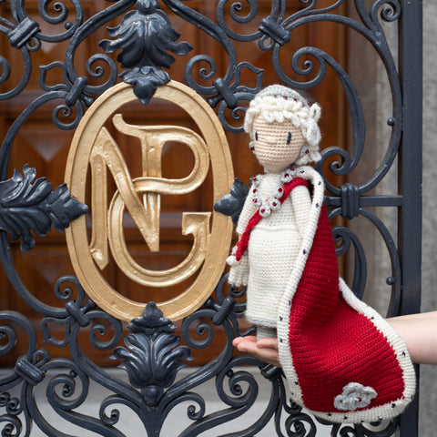 Crochet doll of Queen Elizabeth II outside the National Portrait Gallery gates.