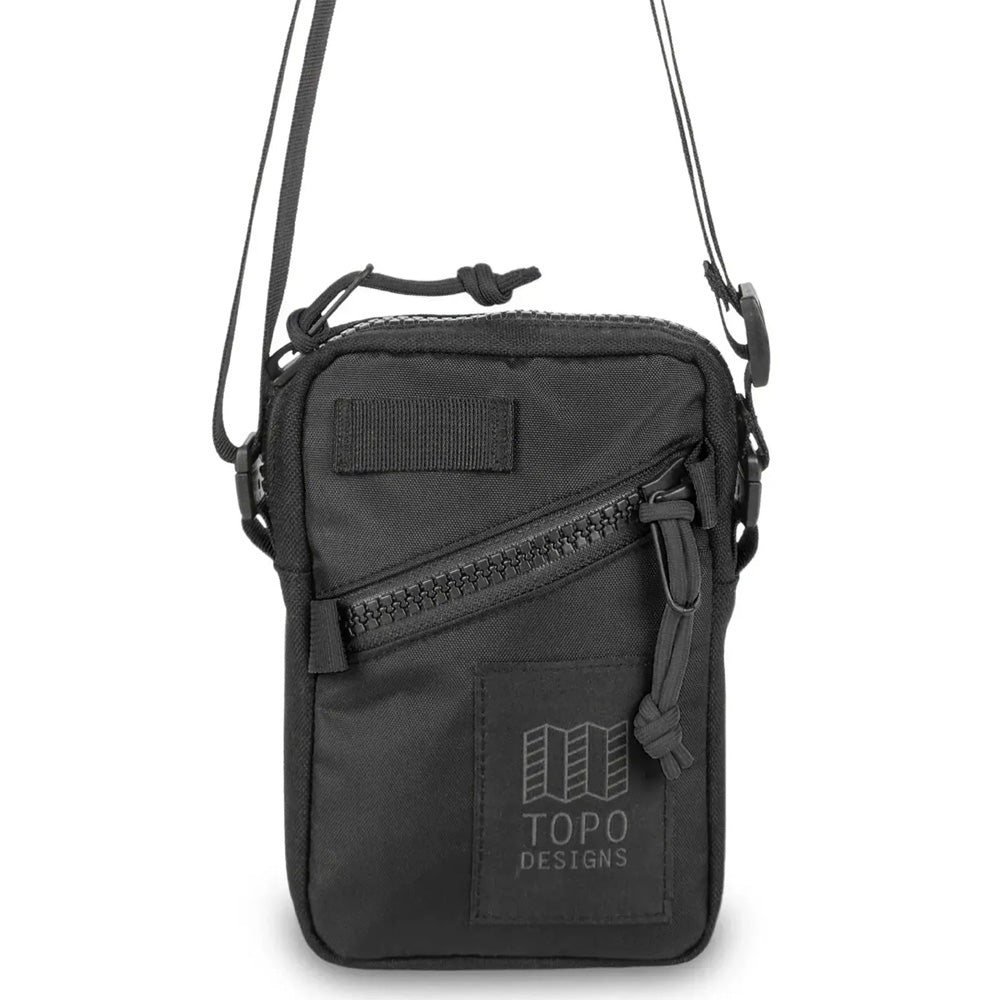 Black zippered crossbody bag with topo designs logo on a white background