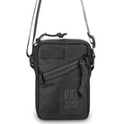 Black zippered crossbody bag with Topo Designs logo on a white background