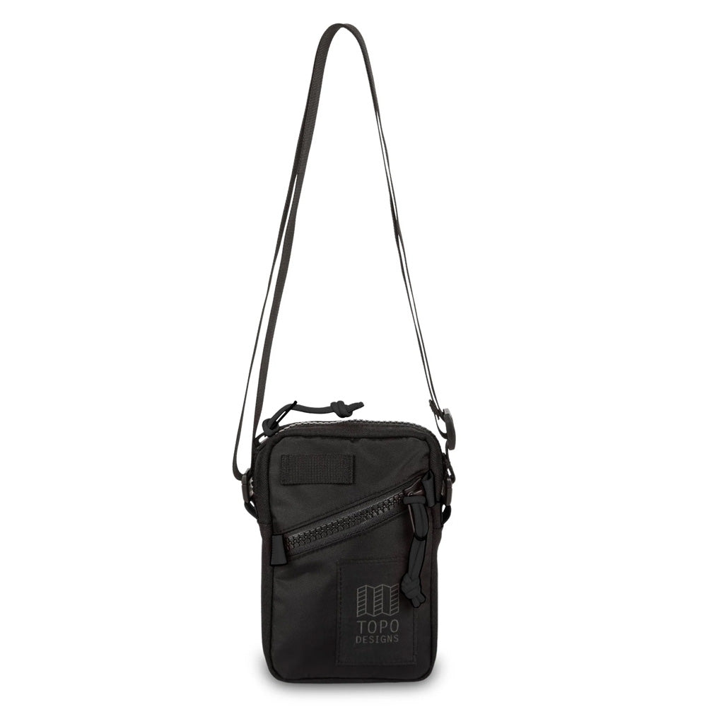 Black crossbody bag with a strap on a white background