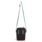 Reverse of small crossbody bag with strap and teal accents on a white background