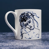 White ceramic mug with dark blue ink line illustration of a woman. 