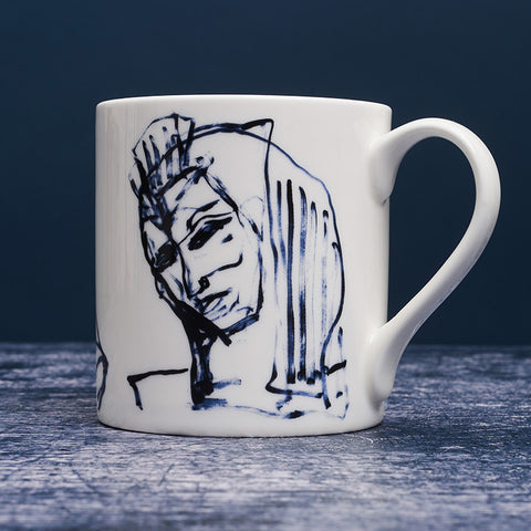 White ceramic mug with dark blue ink design of another woman.