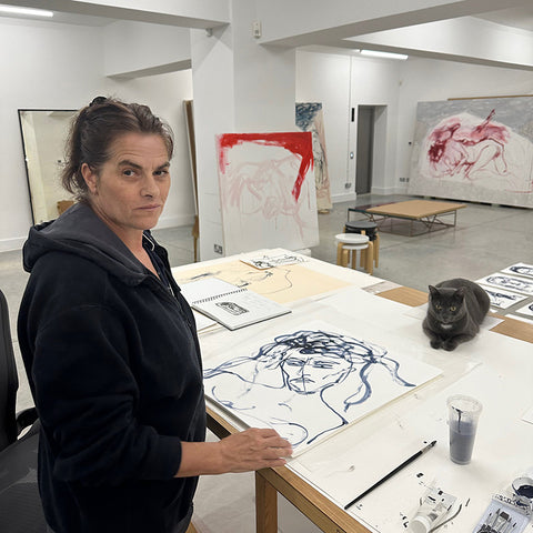 Tracey Emin in her studio with her designs for this collection.  