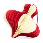 Red and cream striped honeycomb paper Christmas decoration.