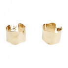 A pair of wide loop earrings made from gold colour textured metal.