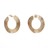 A pair of gold metal round textured earrings.