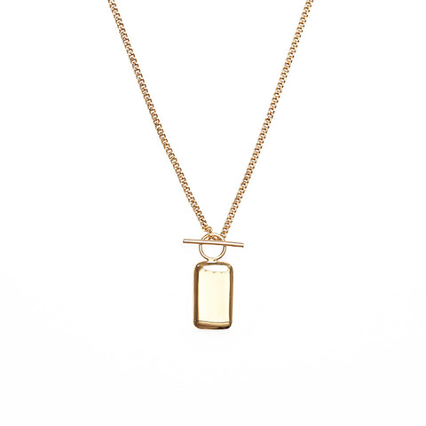 Rectangular gold pendant with hoop and bar hanging from a gold chain necklace.