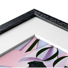 Close-up of a framed magazine with a black frame on a white background