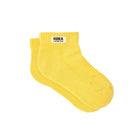 A pair of ribbed yellow socks with white label and the words Roka London against a white background