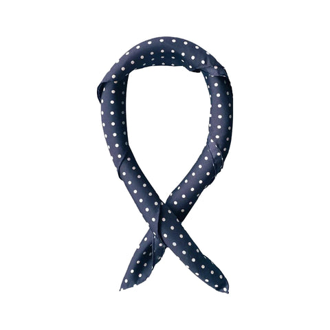 Navy blue bandana with white polka dots tied in a loop.