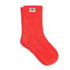 A pair of bright red crew socks with a white and black ROKA LONDON label on the cuff, displayed on a clean white background.