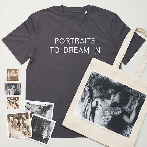 Styled photograph with Portraits to Dream in exhibition t-shirt, tote bag and postcards. 