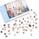 Jigsaw puzzle with pieces laid out in front of the packaging, featuring a photograph of women in colourful dresses.