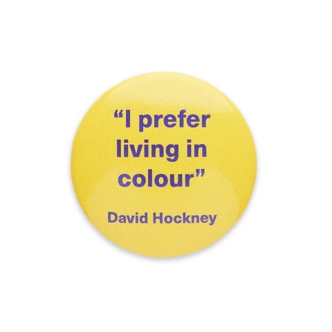 Yellow badge with the quote "I prefer living in colour" by David Hockney