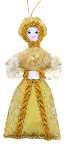 This decoration features a woman in a a long, extravagant, gold gown.