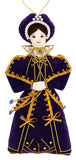 A textile decoration has a woman with dark hair and an elegant dark purple gown with gold trim. 