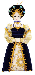 This decoration features a woman with a gold and black head covering and a long gold and black gown. 