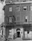 Bomb damage, Berkeley Square, London, showing Yevonde and an assistant in the doorway, with retrieved Day Books and lights NPG x223753
