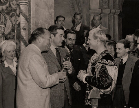 Hal Wallis and Ray Milland present Laurence Olivier with the Academy Award for 'Henry V' on the set of 'Hamlet' NPG x137986
