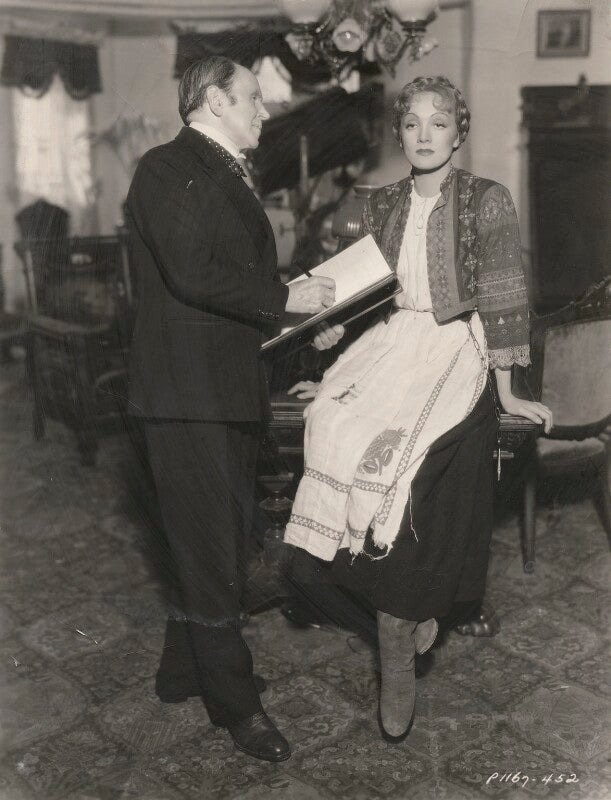 Sir john lavery and marlene dietrich in costume as anna sedlak on the set of 'i loved a soldier' npg x194400