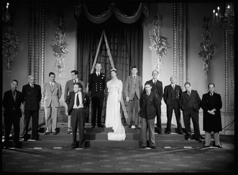 Thirteen unknown sitters in set up photograph for the portraits of queen elizabeth ii and prince philip with their wedding guests npg x158913