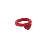 A red glass heart shaped ring.