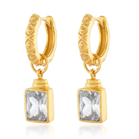 Margot earrings with a clear square crystal hanging from a gold hoop.